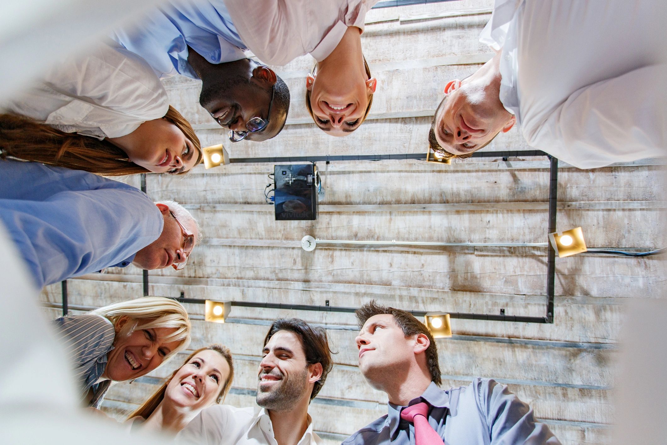 Group of coworkers discussing plans, representing choosing an escape room together