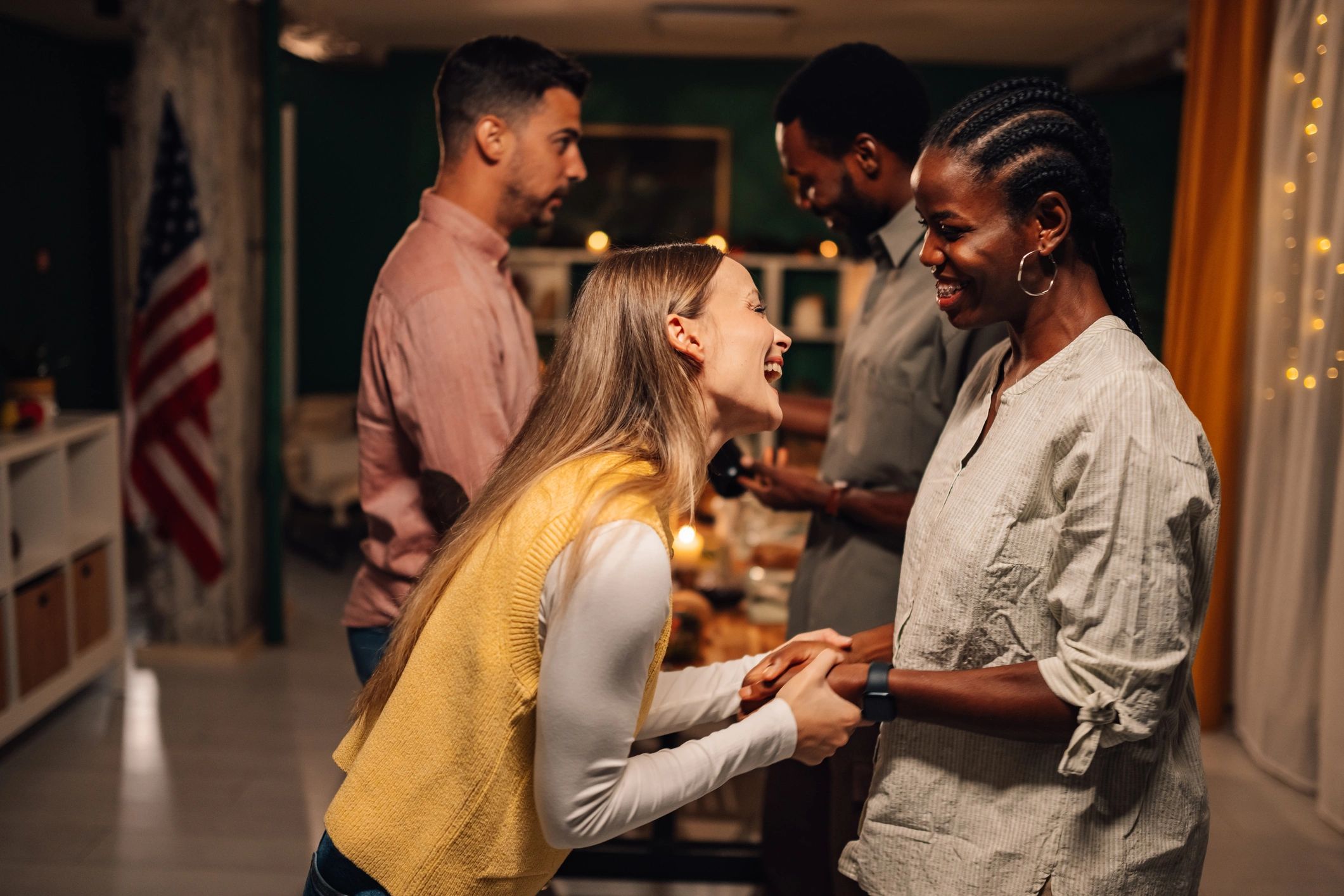 Friends gathered around a table, smiling