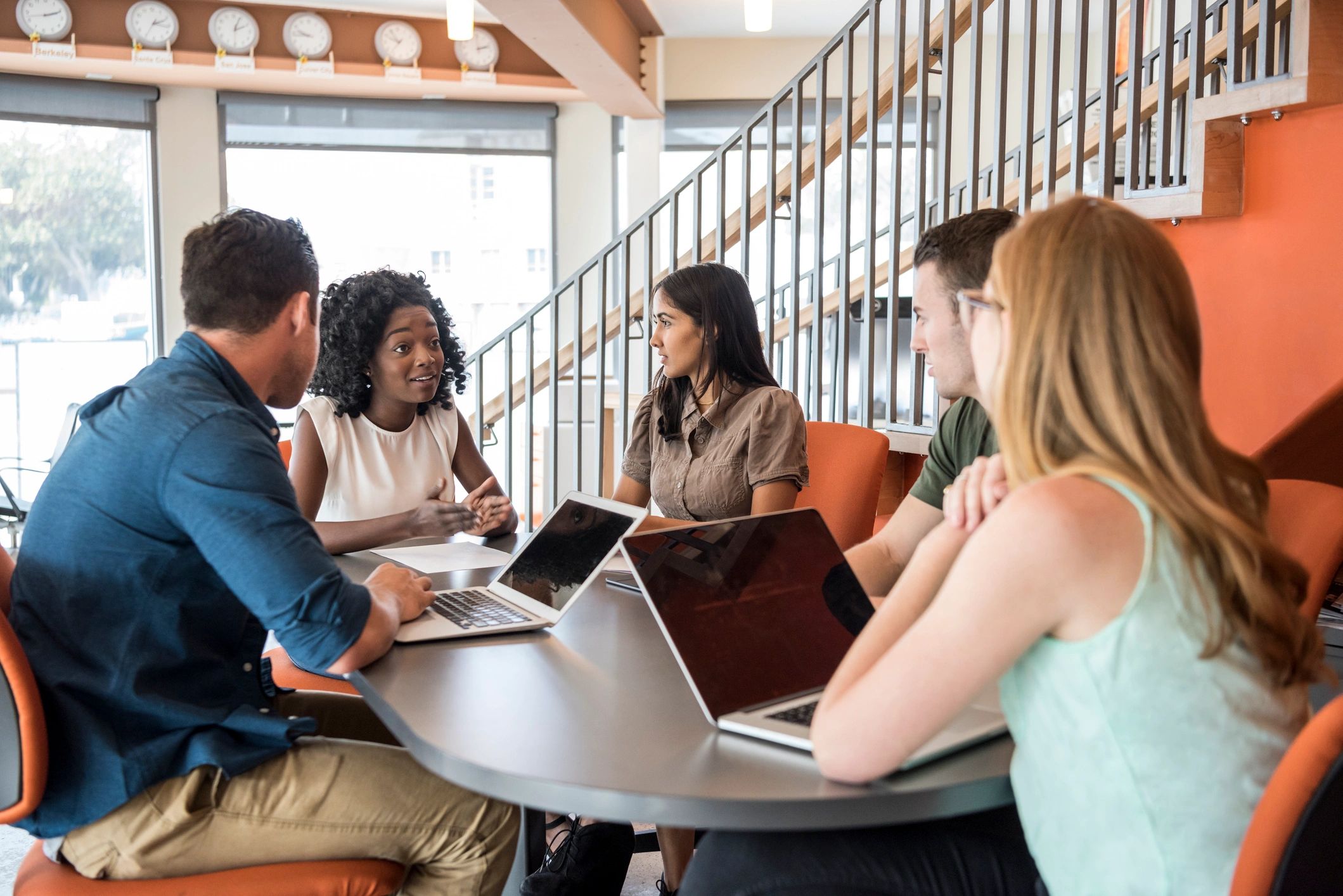 Team members listening in a meeting, representing a group organizer